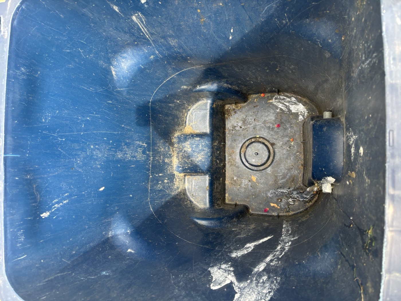 Trash bin interior before cleaning, with grime and residue