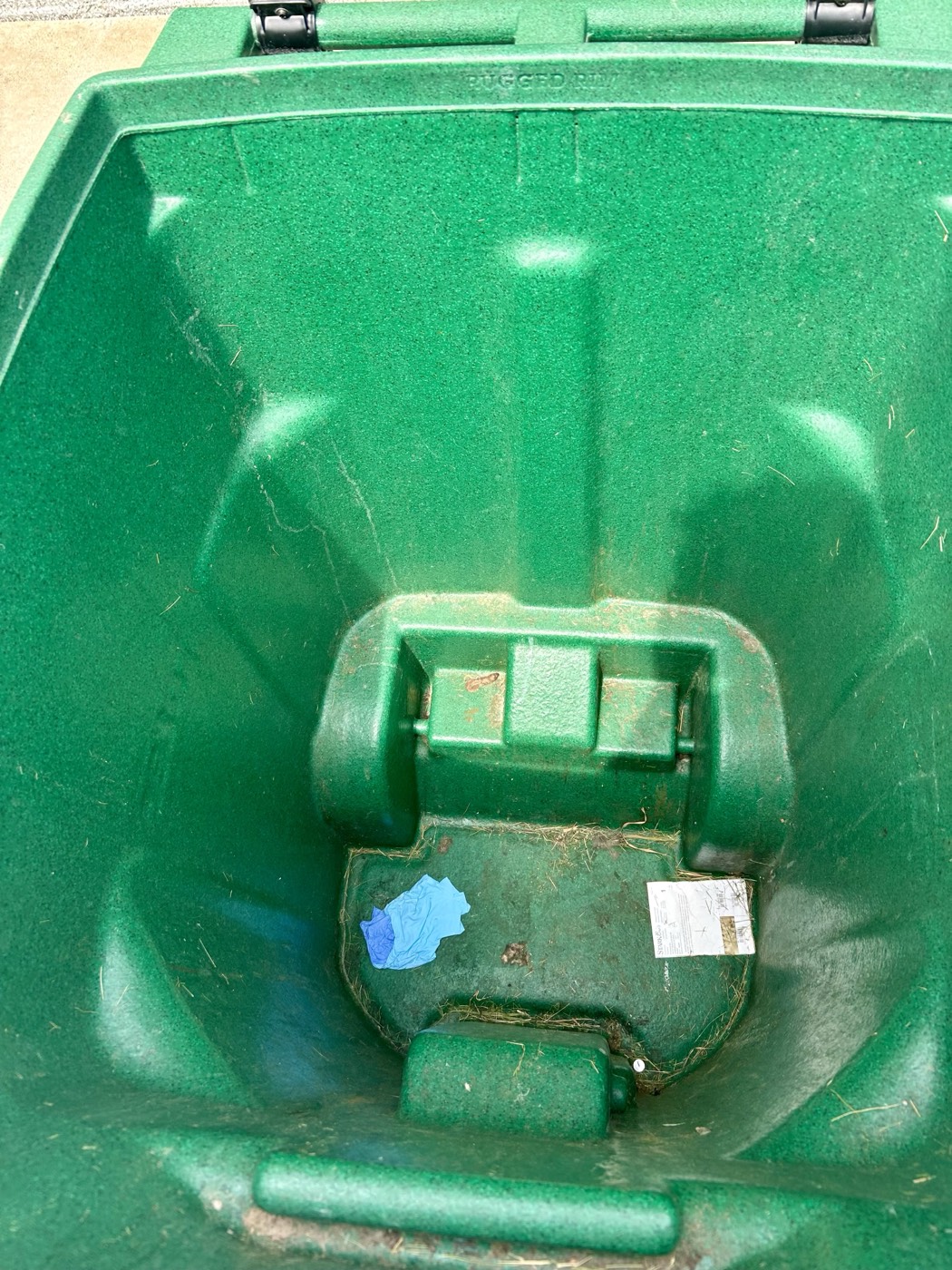 Recycling bin interior before cleaning, with stuck-on residue